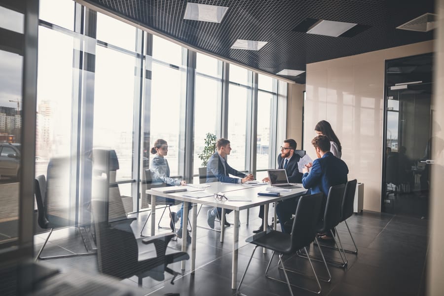 The development team in a glass-walled conference room